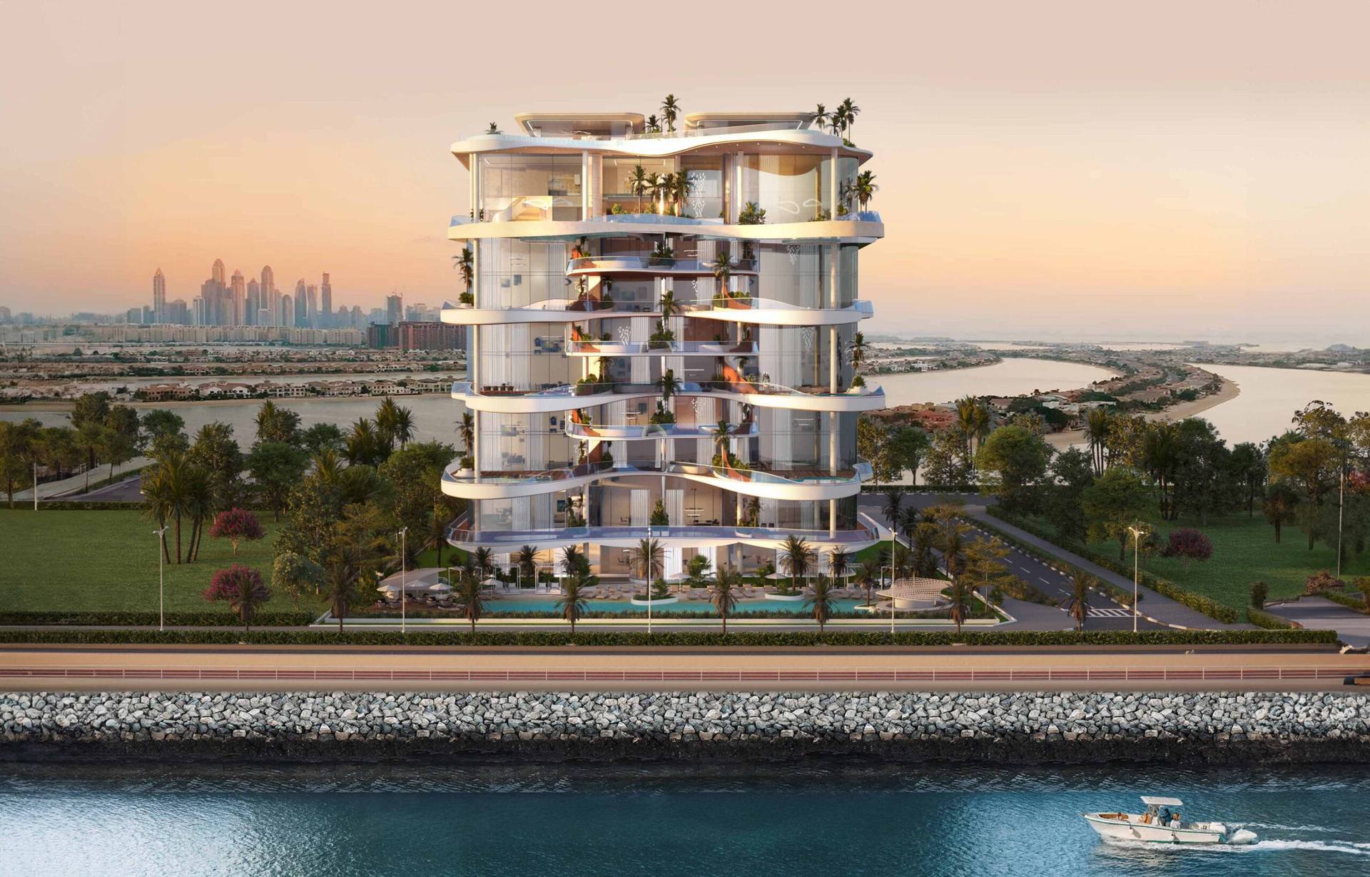 Waterfront residential tower with curved terraces at sunset, with the Dubai skyline in the background